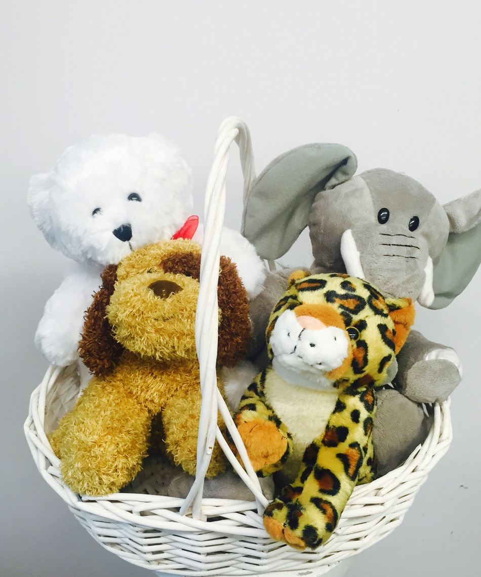 Basket of Cuddles featuring a classic stuffed bear, puppy, zoo animal and elephant. 