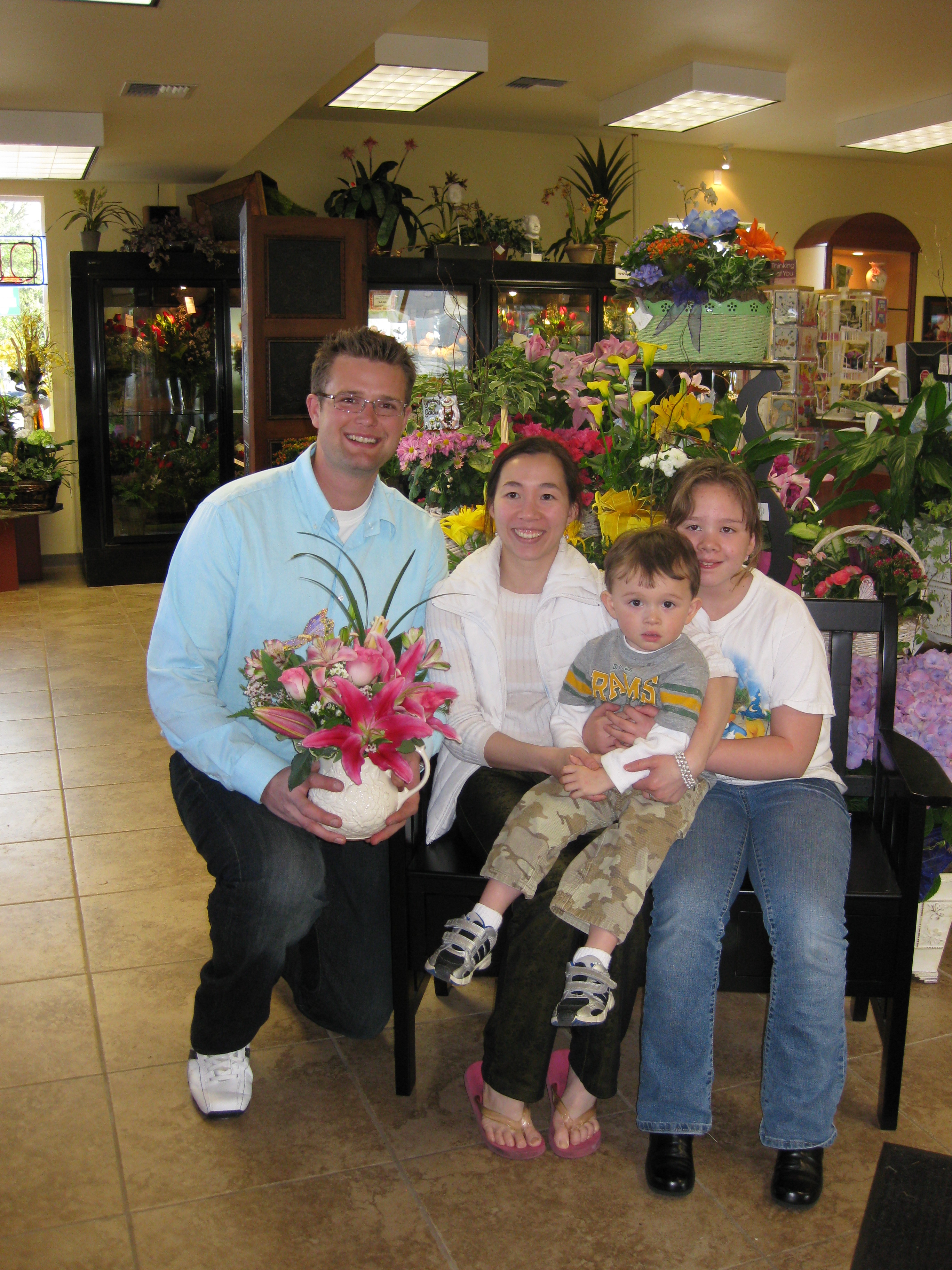 pictured: Adam Van Winkle (owner of Stadium Flowers) and Nu Truong (winner) with her two children.