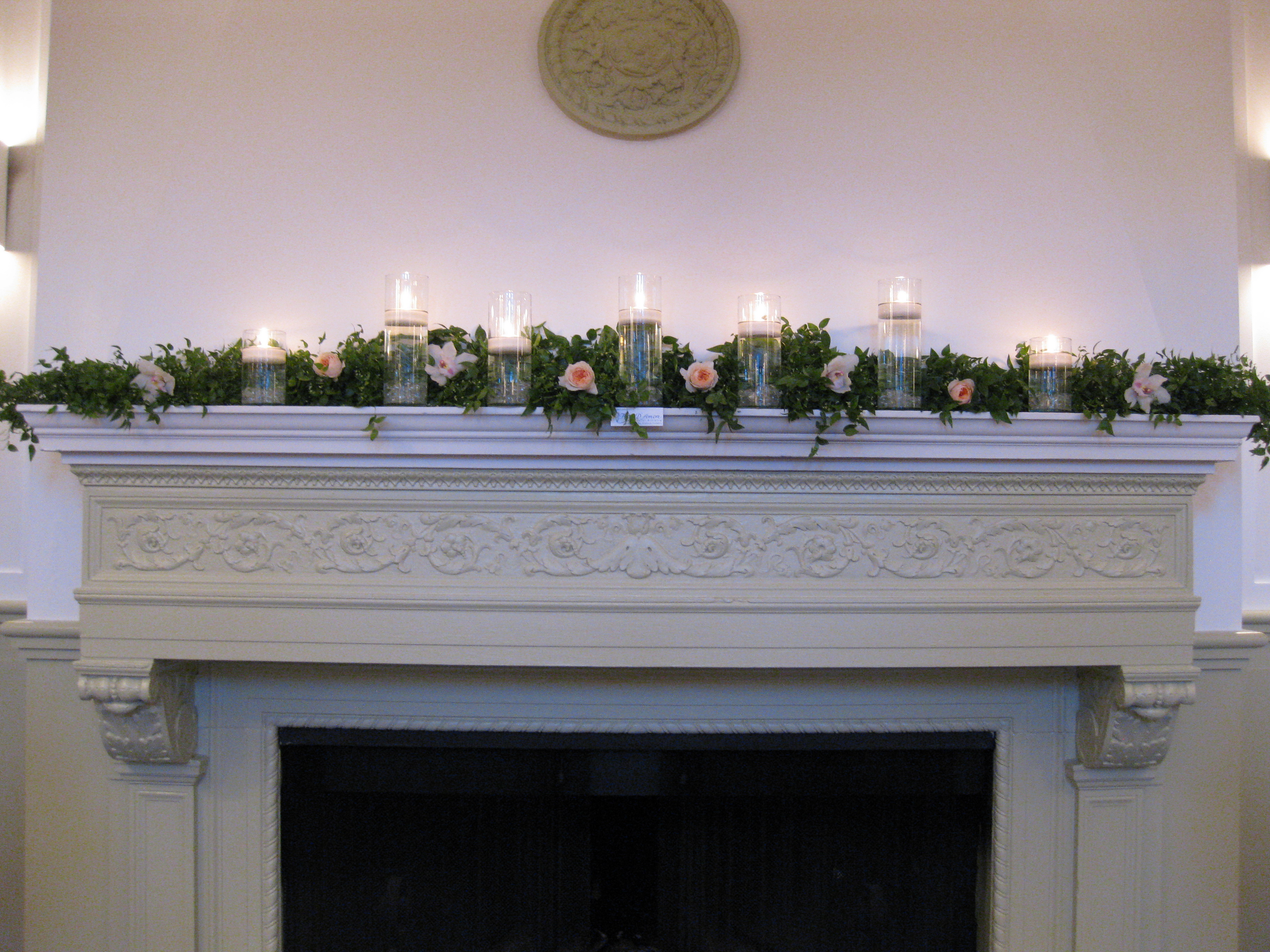mantle greens, flowers, and candles