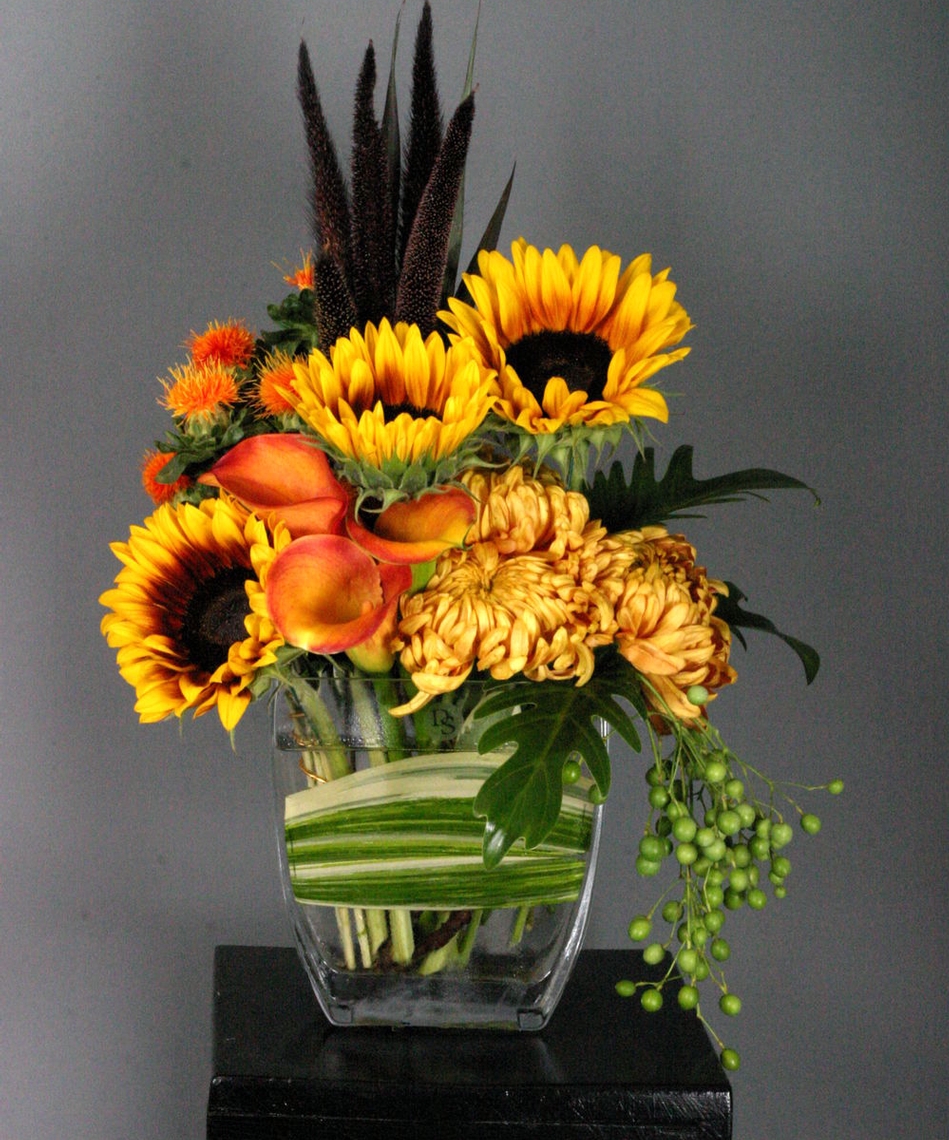 Sunflowers, Safflower, Millett, Mums, and China Berry are in abundance in this beautiful Autumn floral. 