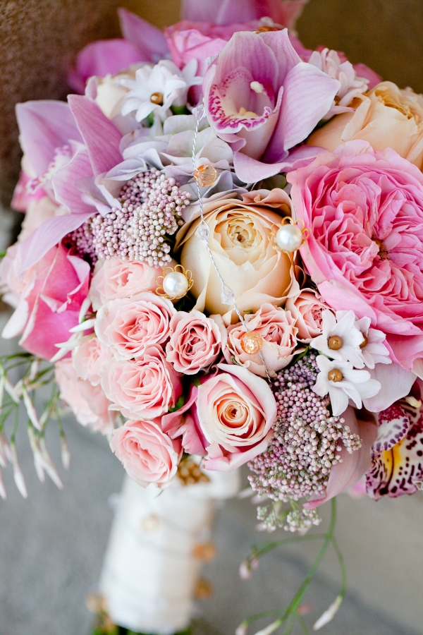 Pink garden roses with gold and pearl accents create a sweet and romantic bridal bouquet 