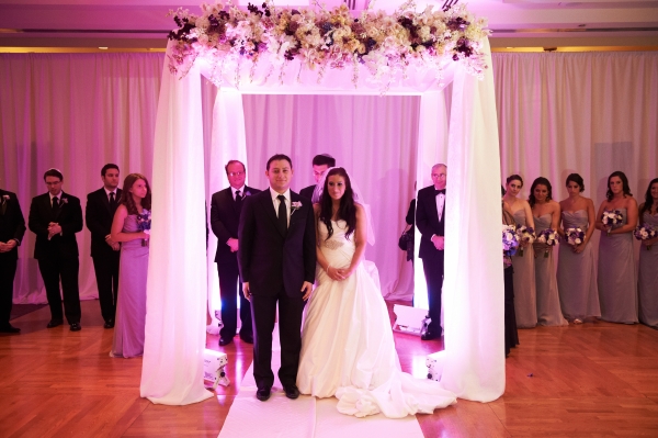 Custom chuppah with floral mantel and sheer white draping