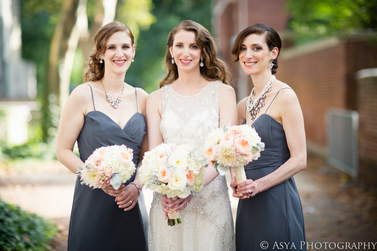 An elegant white and gray bridal party with bouquets