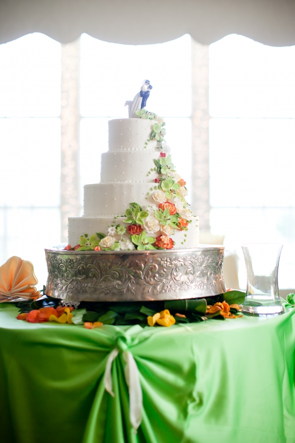 Wedding cake with flowers  on a silver pedestal 