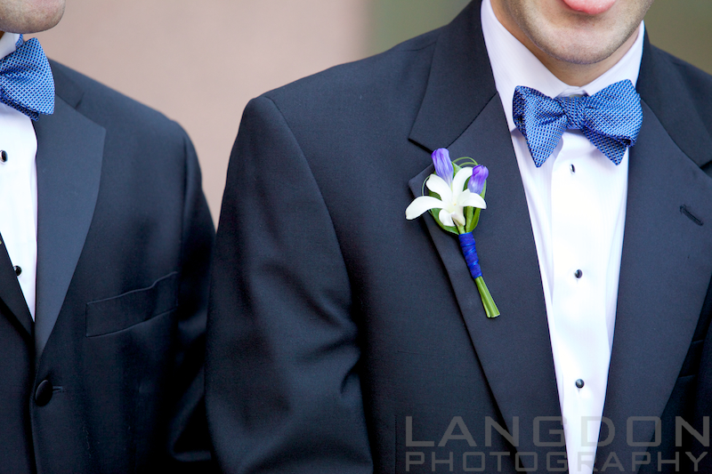 The groom wore a white orchid boutonniere with royal blue ribbon