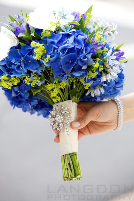 A crystal pin adds a glamorous touch to the bridal bouquet