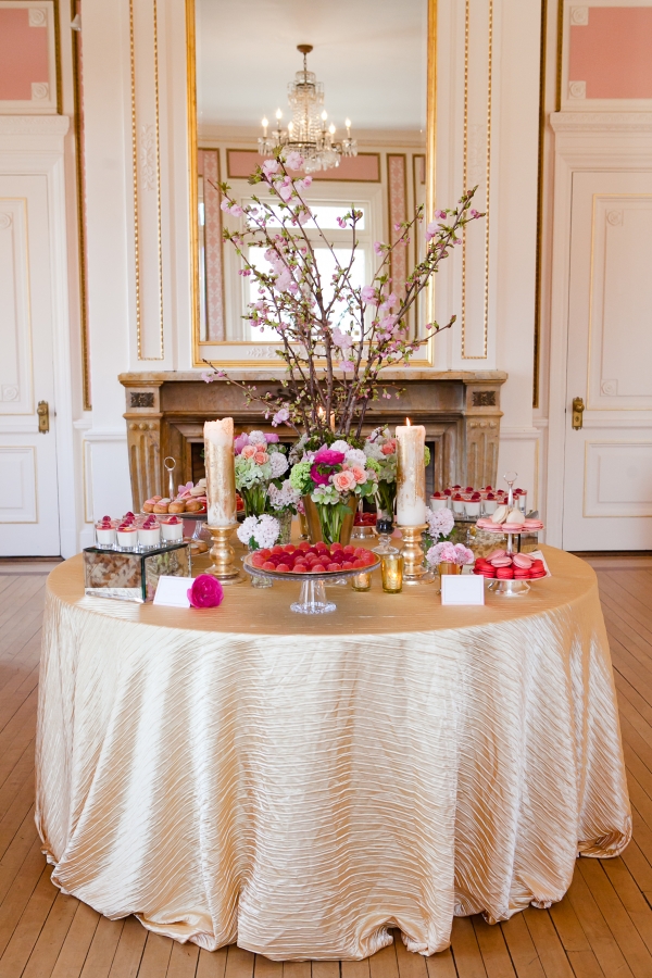 Fresh florals mixed with delectable treats create a decadent dessert table