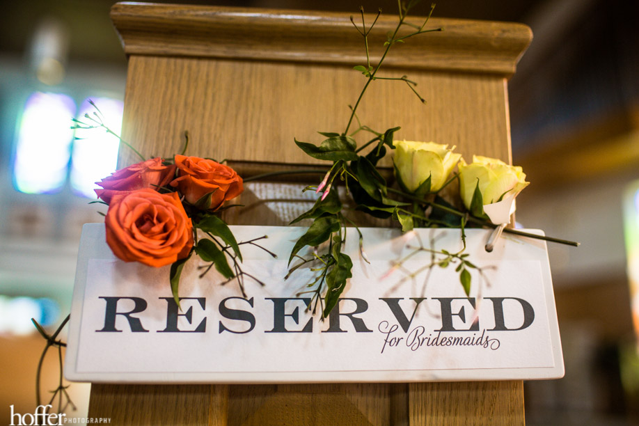 A custom sign with flowers designated the family pews