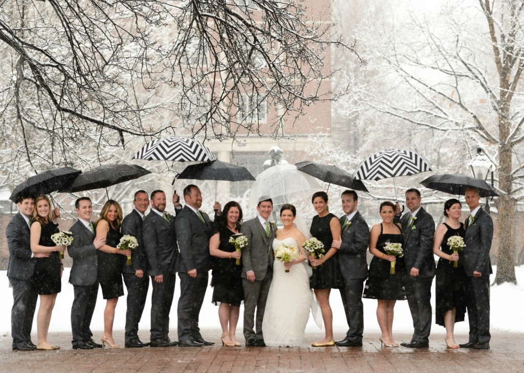 Braving the winter wonderland, the wedding party posed with stylish black & white chevron umbrellas