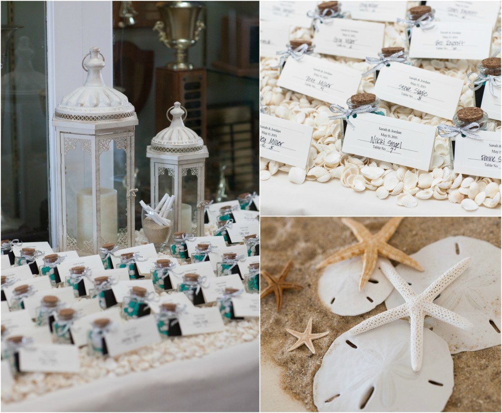 sand and shells decorate the escort card table