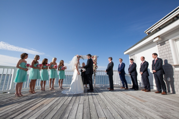 Outdoor wedding complete with an ocean backdrop and sunny skies.
