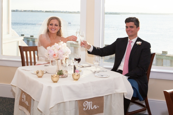 The bride & groom toast at their sweetheart table.