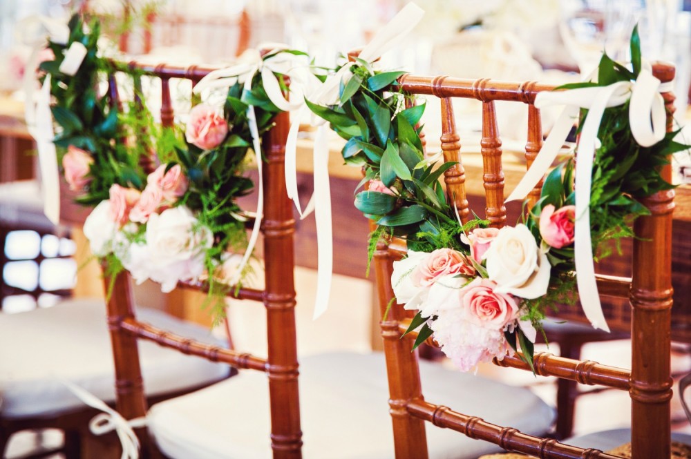 Floral garland on sweetheart table chairs