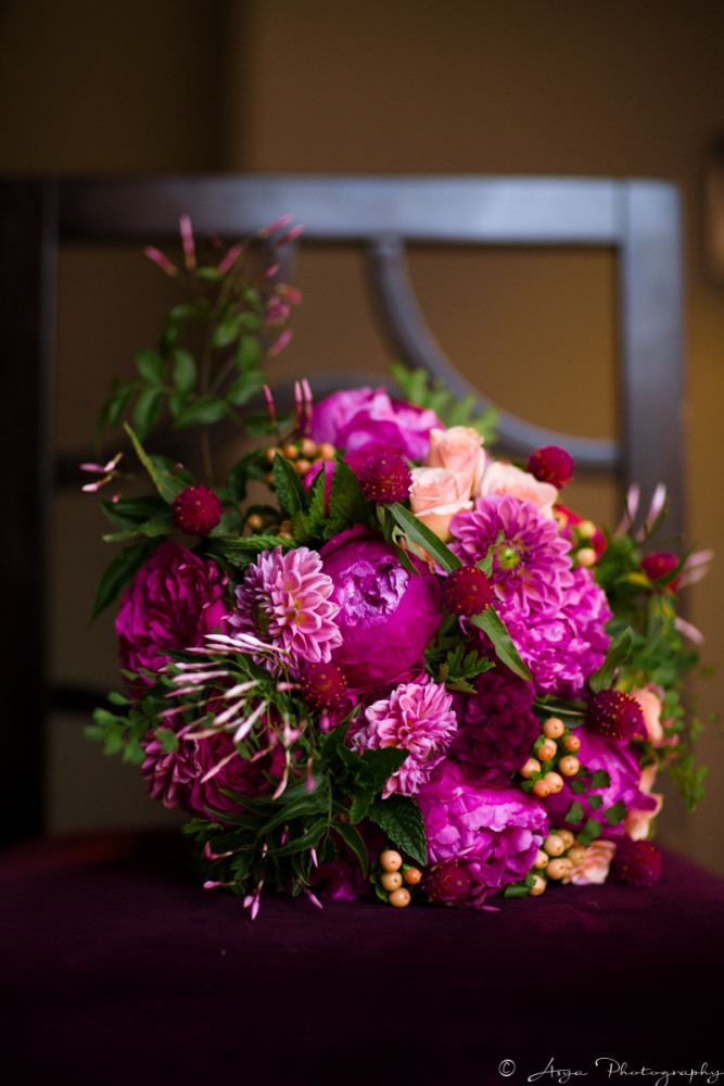garden style bouquet of hot pink, peach and fuchsia flowers including dahlias, garden roses and celosia