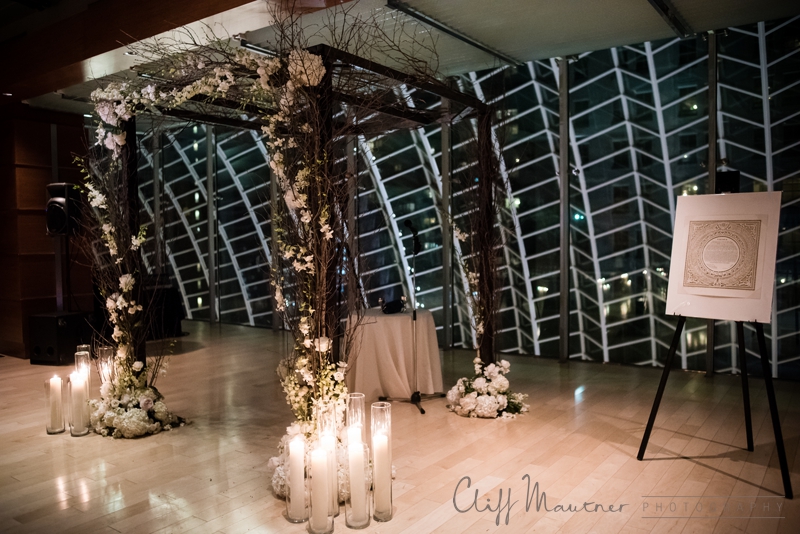 custom chuppah of white flowers and candlelight 