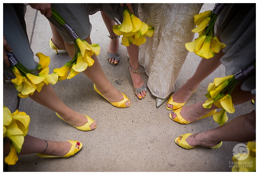 bright yellow callas add a pop of color to grey bridesmaids dresses