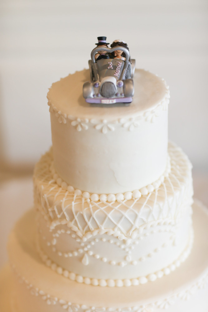 A classic tiered wedding cake with a custom bride and groom topper