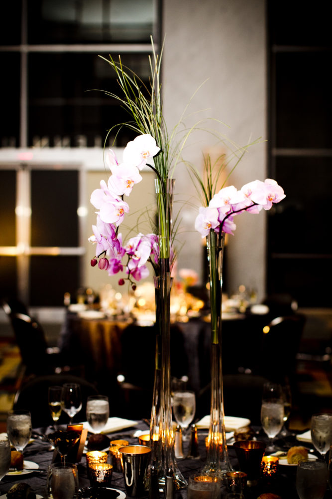 phalaenopsis orchid stems in tall Eifel tower vases with bear grass